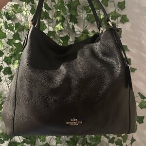 Coach Black Pebble Leather Edie Shoulder Bag 
Has black fabric with coach logo